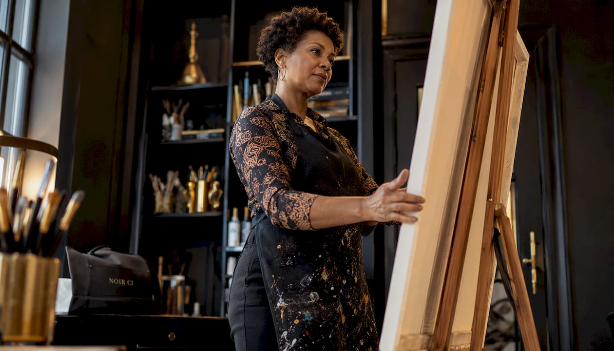 Artist inspecting a stretched canvas frame