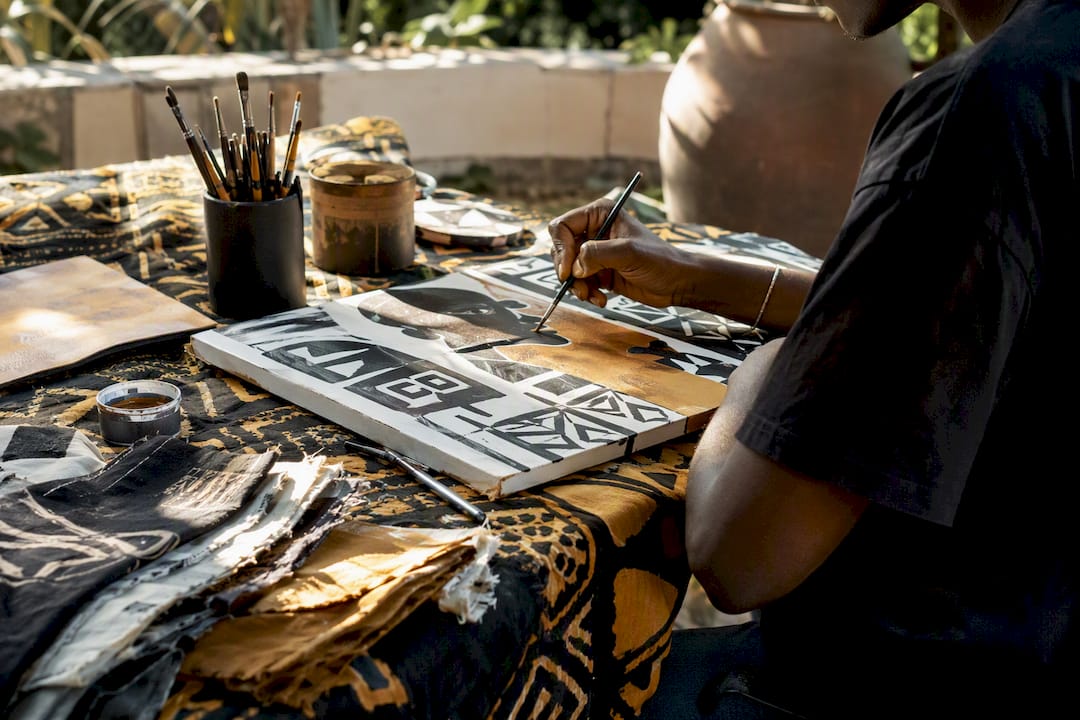 Artist workspace with African textile and canvas art