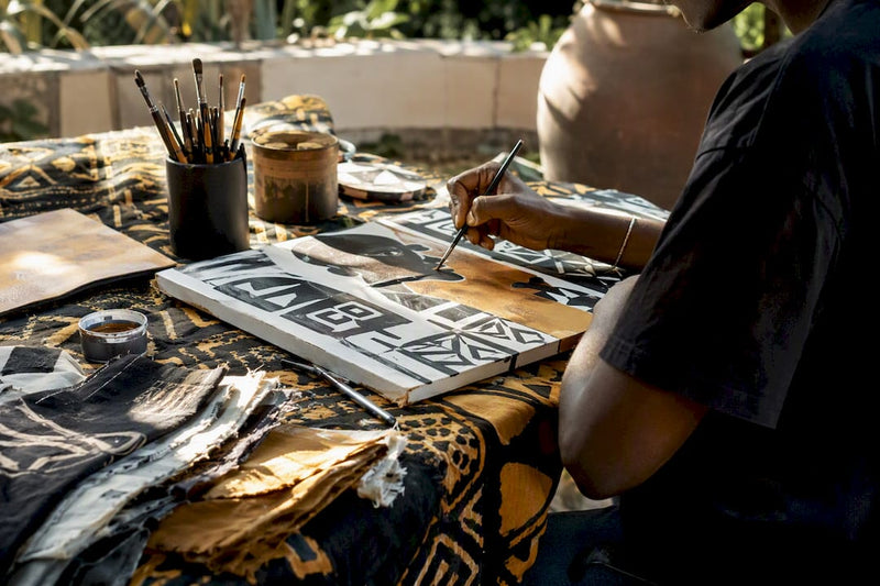 Artist workspace with African textile and canvas art