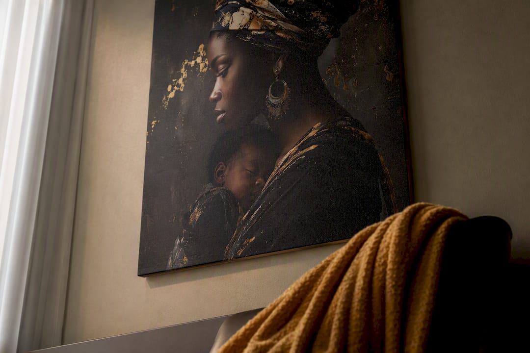Black motherhood canvas art on living room wall