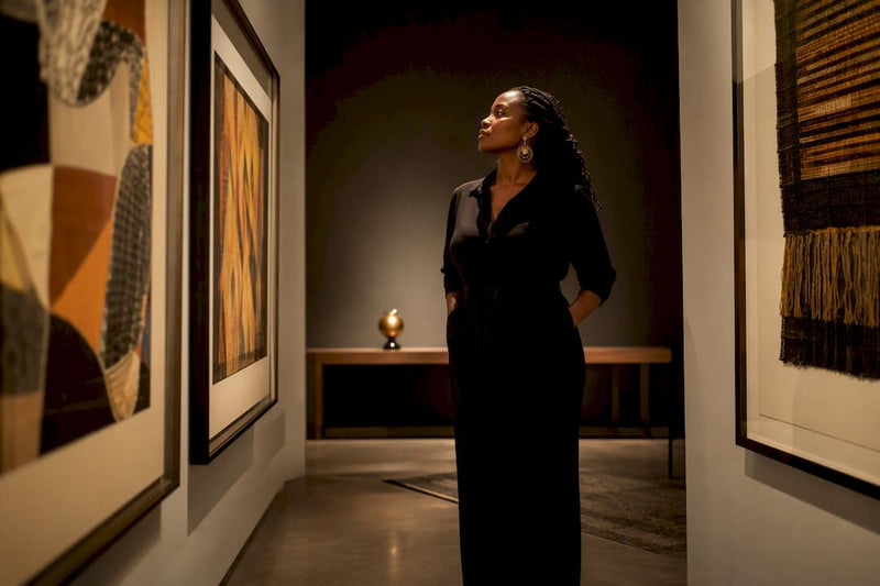 Curator viewing culturally focused Black art