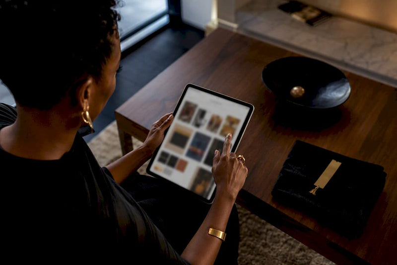 Black art buyer browsing curated digital art platforms