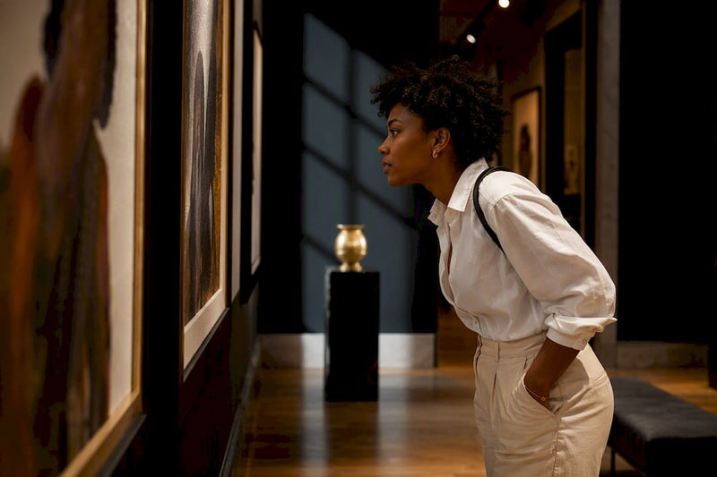 Buyer studying Black art prints in gallery