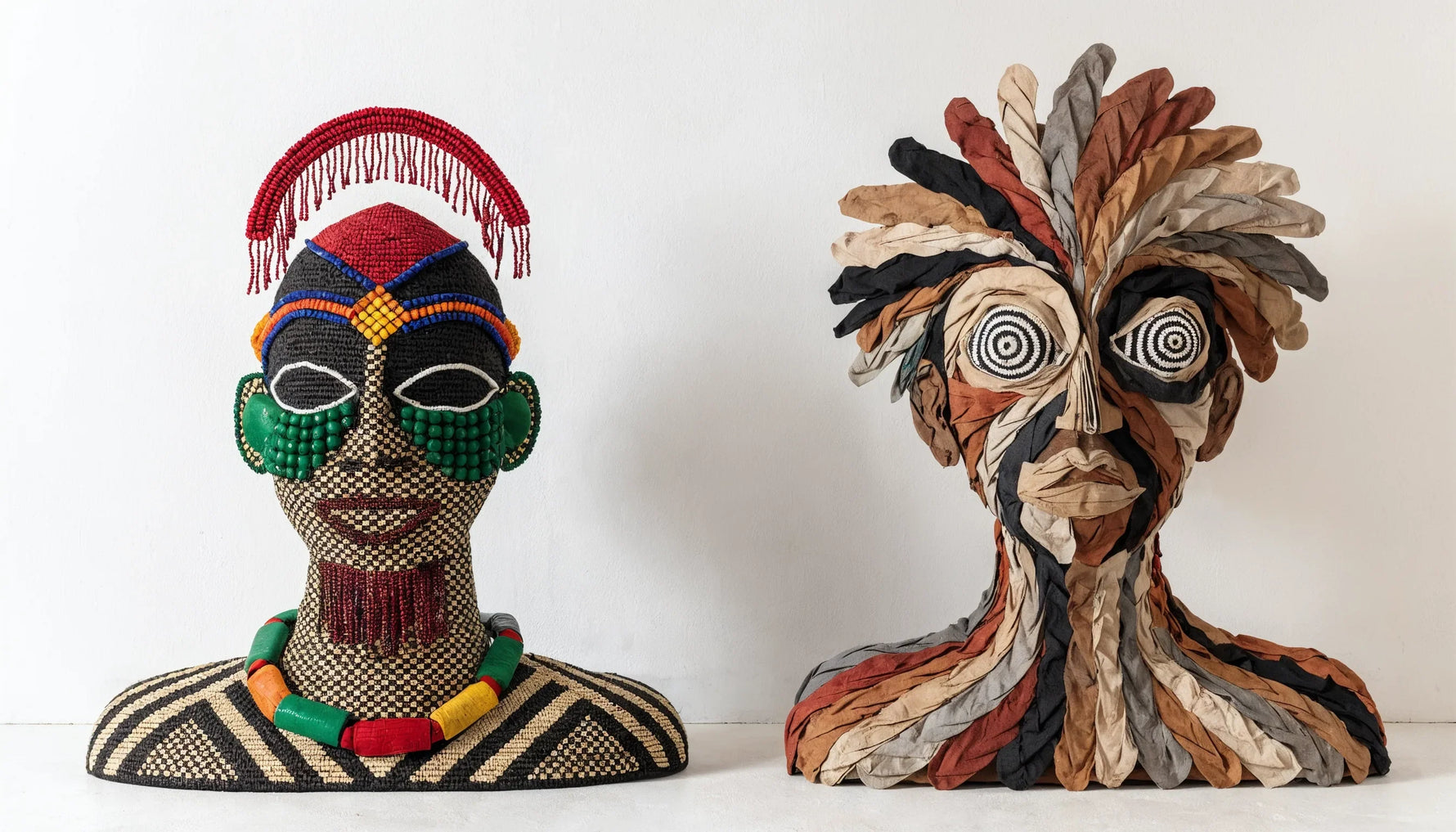 Two original African-motif artworks side by side on a clean gallery wall, a thoughtful comparison, minimalist.