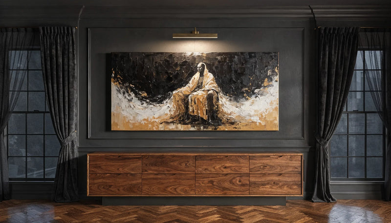 A warm toned canvas painting lit by a brass picture light on a near black living room wall above a walnut console