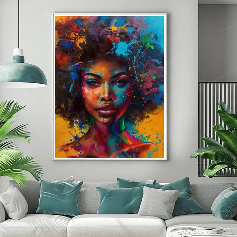 Afrofuturism art in a white frame above a gray sofa with teal pillows, splash-paint portrait of a Black woman with neon afro