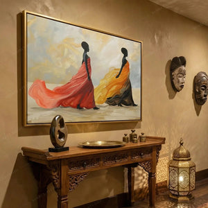 African wall decor in a warm hallway, gold framed gown painting beside carved masks and a glowing Moroccan lantern