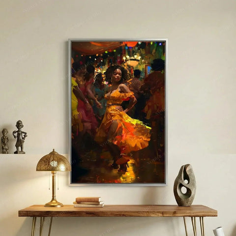 Melanin art canvas of a woman salsa dancing in orange, silver frame above a wood console with a brass lamp