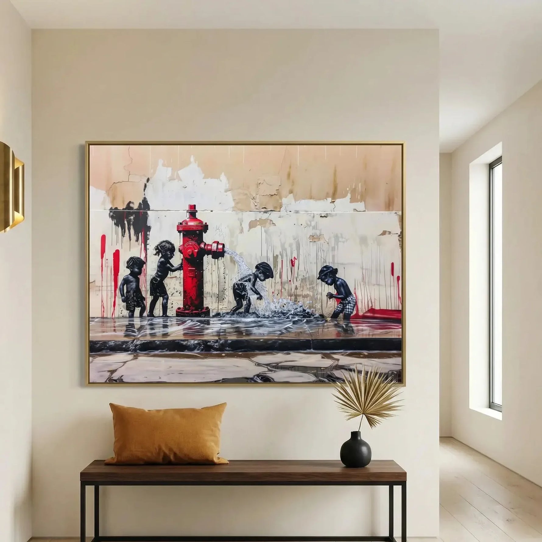 Black family wall art in a gold frame above an entryway bench with a mustard cushion and dried palm in a dark vase