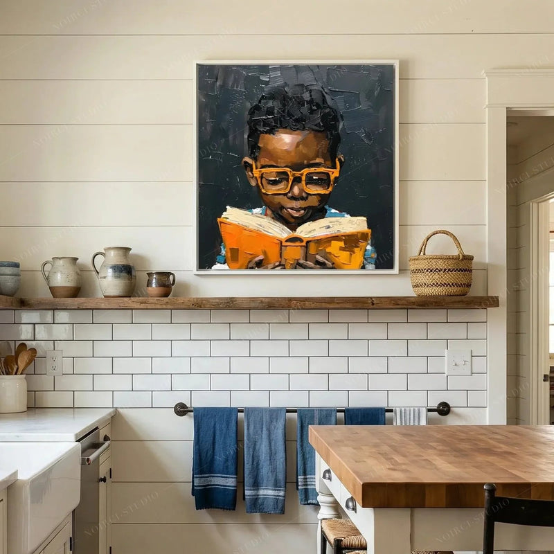 Black Boy Joy Reading canvas displayed on an open kitchen shelf above white tile