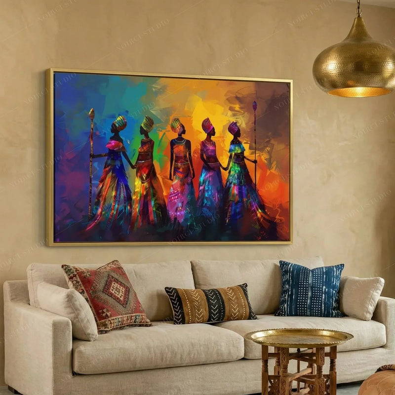 African wall art for living room, gold framed tribal women above a cream sofa with kilim and mudcloth pillows