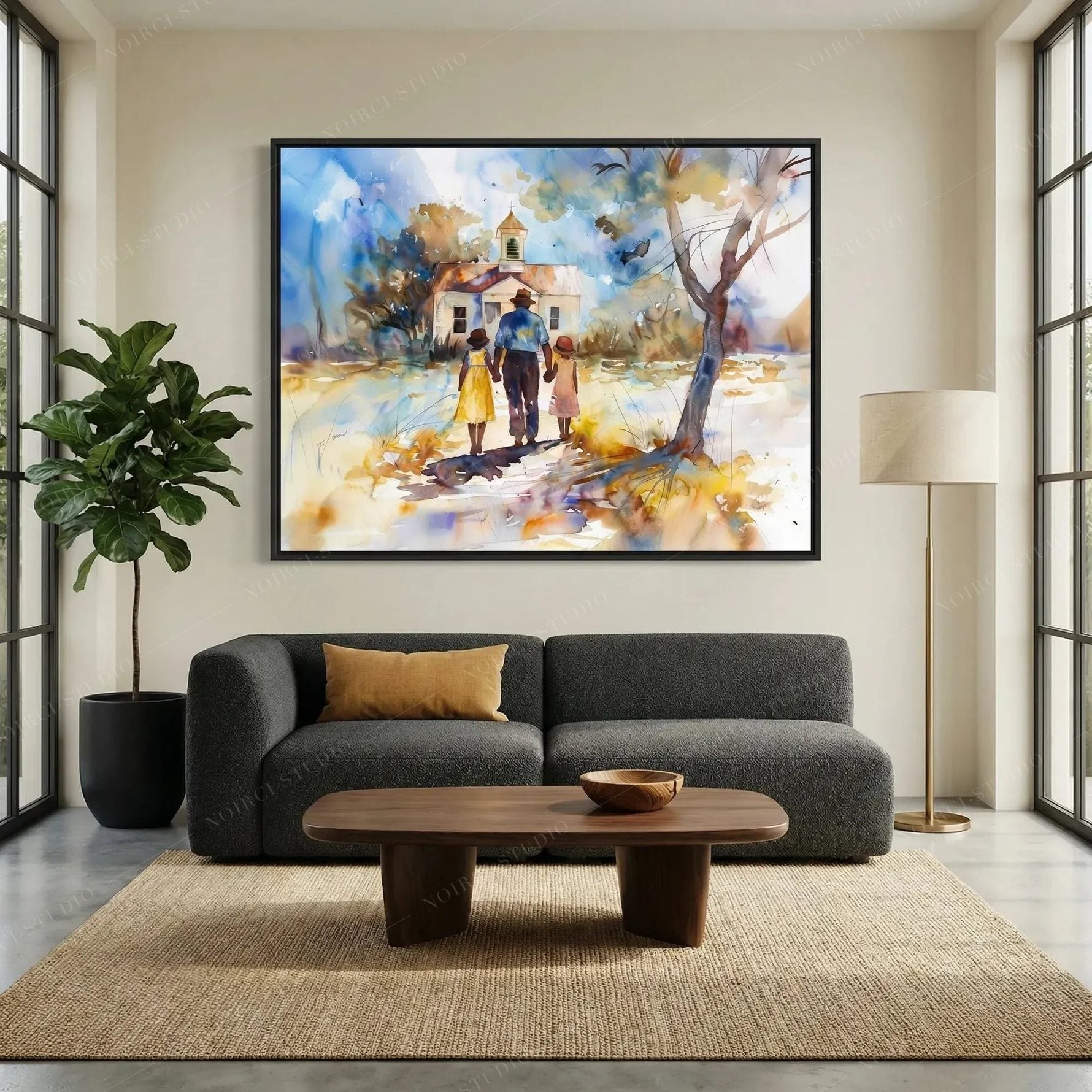 African American wall art above a charcoal sofa, chapel scene in a black frame beside a fiddle leaf fig