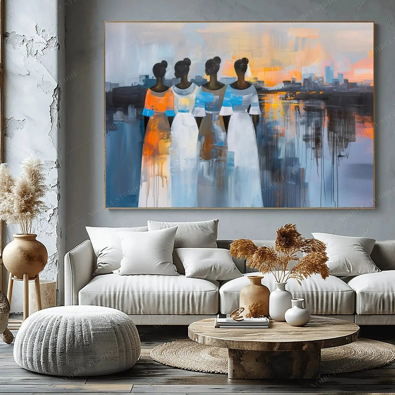 Black art for living room, four women at sunset above a greige sectional with pampas grass and a round wood table
