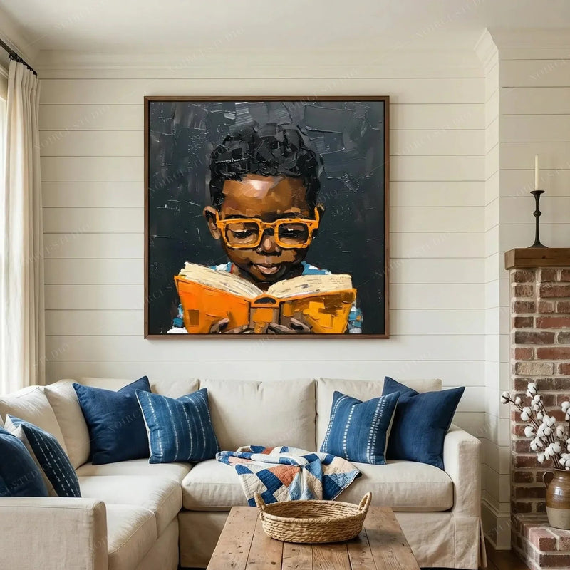 Black Boy Joy Reading wall art above a beige sofa with indigo pillows in a farmhouse living room