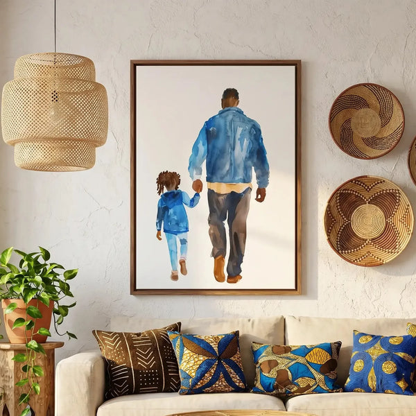 Black fatherhood wall art, watercolor dad and daughter holding hands, walnut frame above a sofa with mudcloth pillows