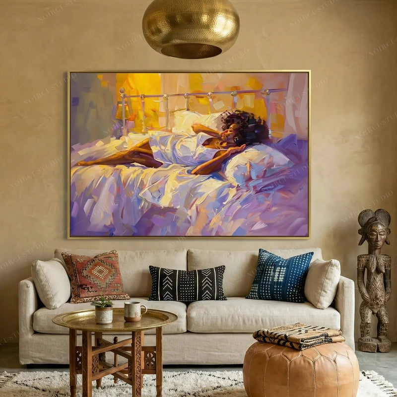 Afrohemian decor, gold framed morning painting above a cream sofa with mudcloth pillows and a carved statue
