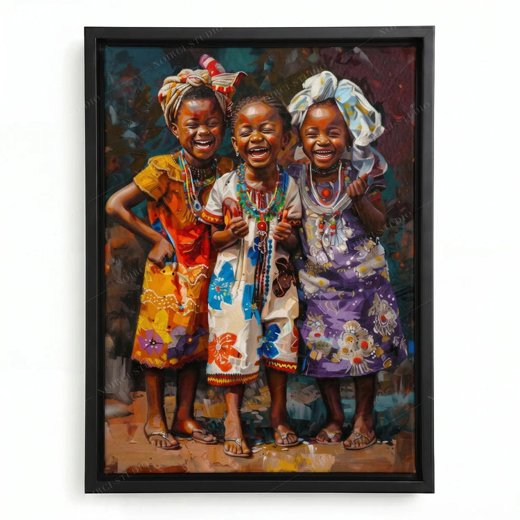 African canvas art in a black floating frame, three laughing African girls in floral dresses and beaded necklaces