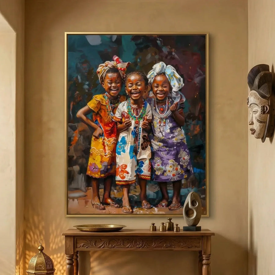 African American art for the wall, joyful girls canvas in a gold frame above a carved console with a wall mask nearby