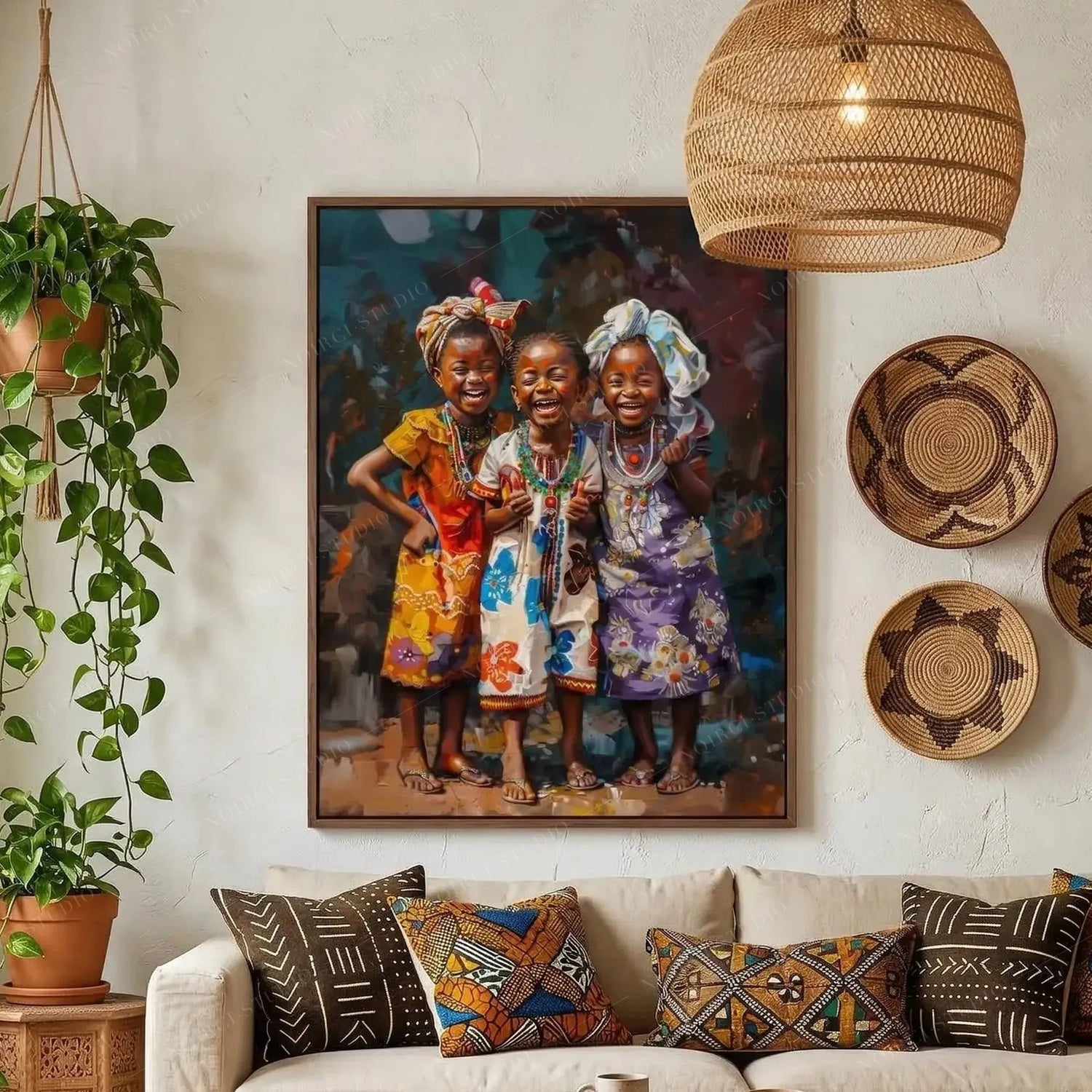 African wall art of three laughing girls in headwraps above a cream sofa with mudcloth pillows in a boho living room