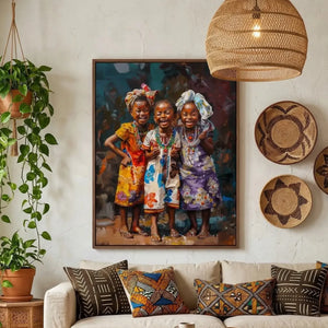 African wall art of three laughing girls in headwraps above a cream sofa with mudcloth pillows in a boho living room