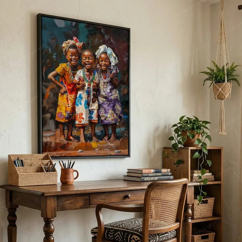 African American art for a home office, three smiling girls canvas above a wood desk with a cane chair