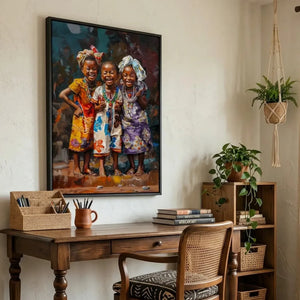 African American art for a home office, three smiling girls canvas above a wood desk with a cane chair