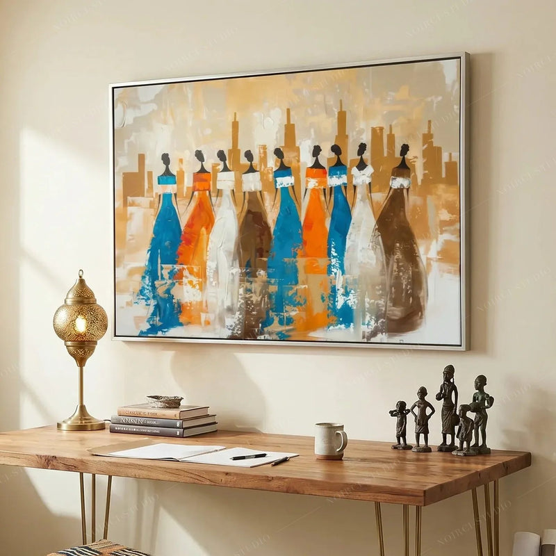Ancestors African American wall art for a home office, white framed nine tribal women above a wood desk with brass lamp