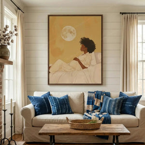 Black art for living room, maternity moon painting above a beige couch with indigo pillows on a white shiplap wall