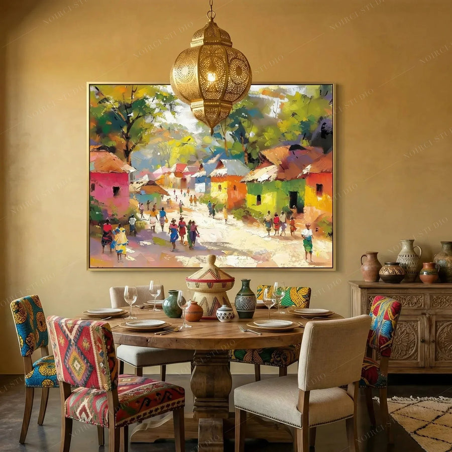 African American dining room art, gold-framed village scene in a mustard dining room with a brass Moroccan lantern