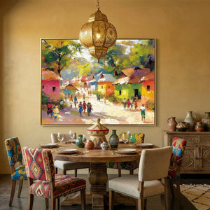 African American dining room art, gold-framed village scene in a mustard dining room with a brass Moroccan lantern