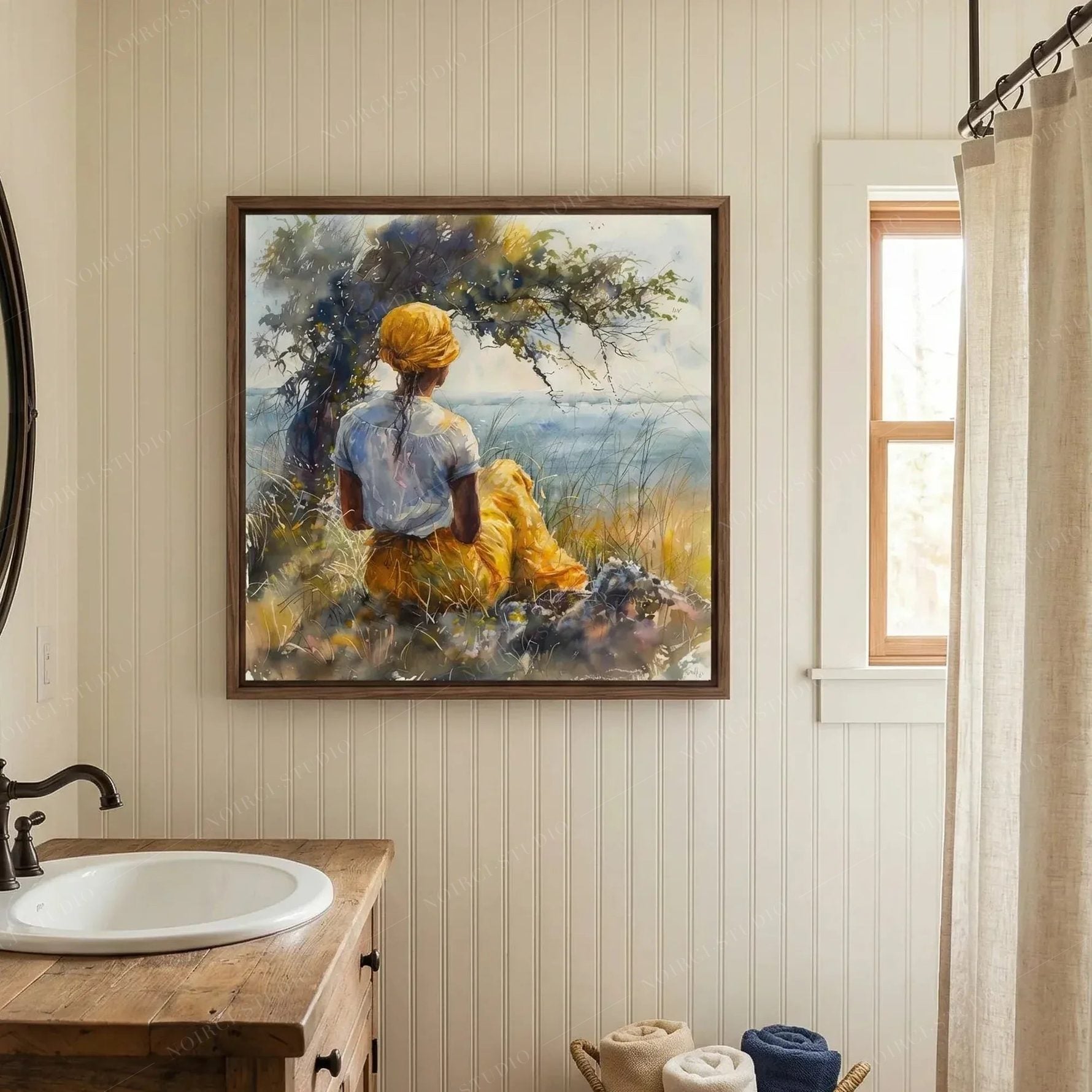 Black bathroom wall art, woman by the sea watercolor above a wood vanity with a white basin