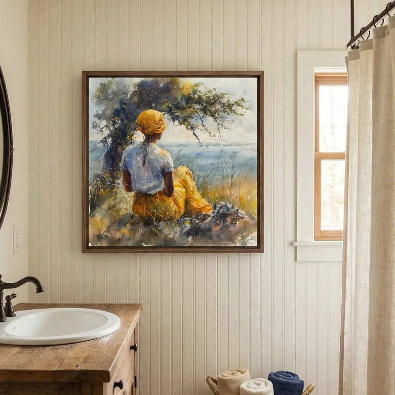 Black bathroom wall art, woman by the sea watercolor above a wood vanity with a white basin