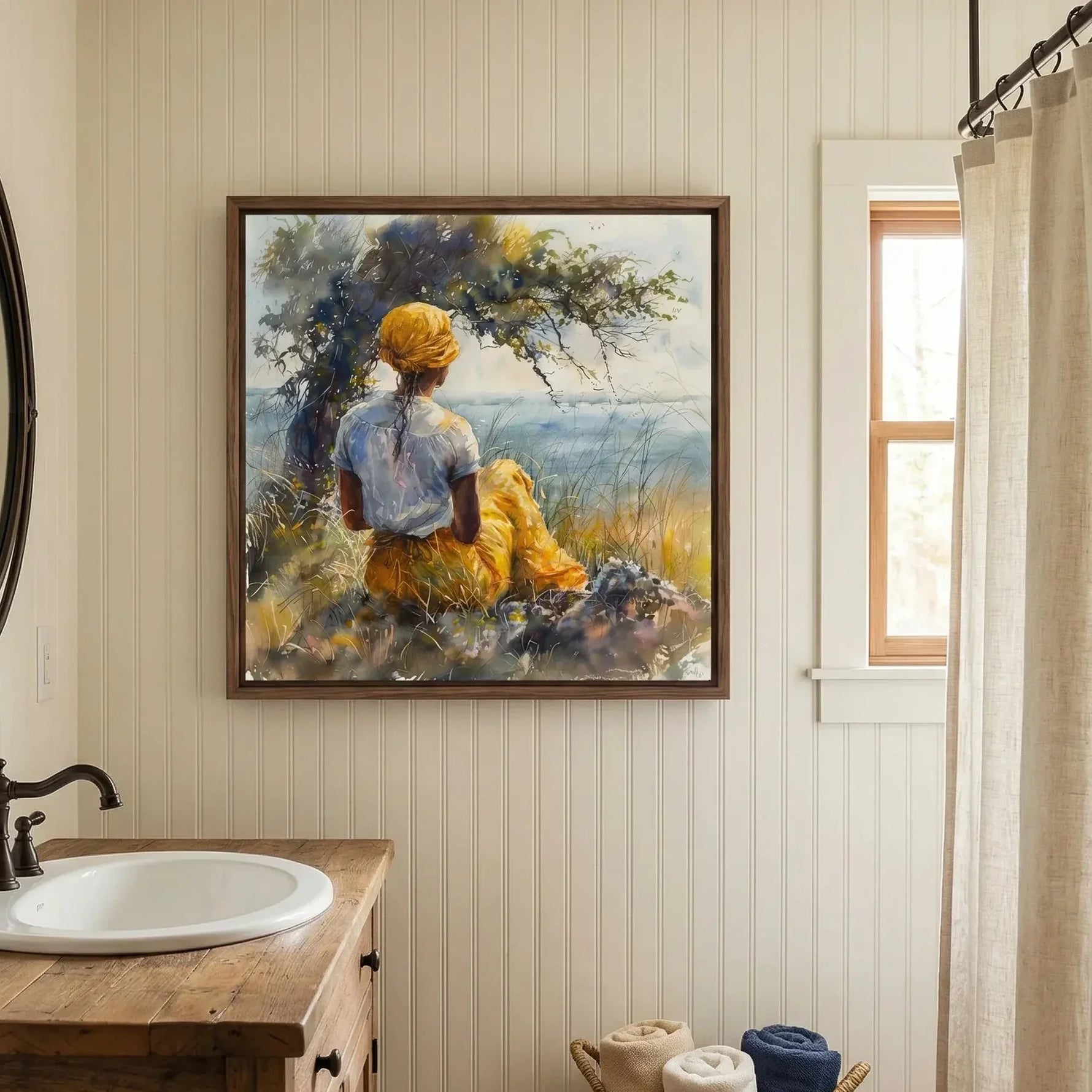 Black bathroom wall art, woman by the sea watercolor above a wood vanity with a white basin