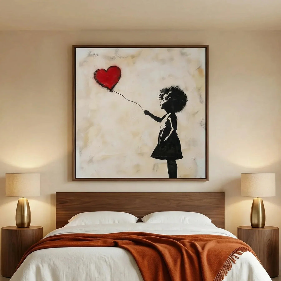 African American art for a bedroom, heart balloon girl in a walnut frame above a platform bed with a rust throw