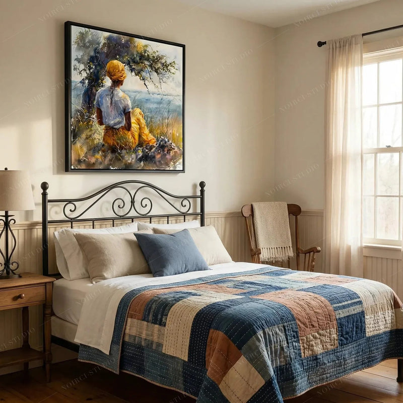 Black art for the bedroom, woman under a tree watercolor above an iron bed with a patchwork quilt
