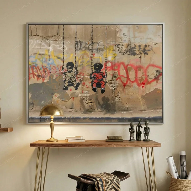 Black entryway art, swings stencil in a silver frame above a wood console with a brass lamp and carved figures