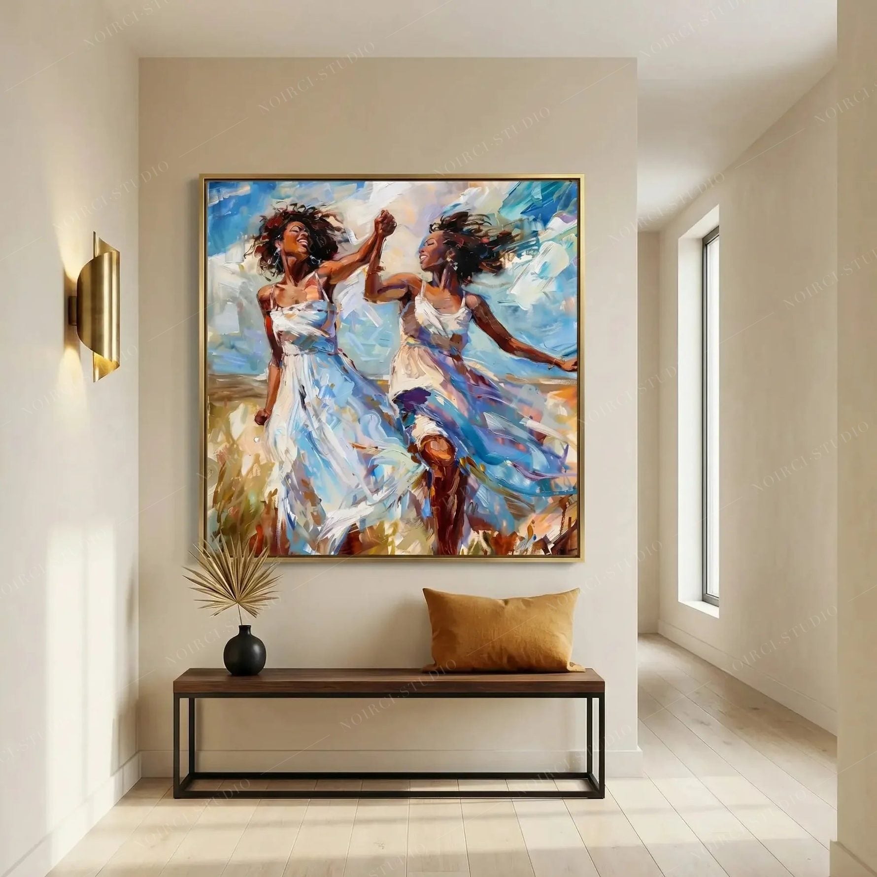 Black wall art in a minimalist entryway with brass sconce and wood bench, gold-framed painting of two women dancing