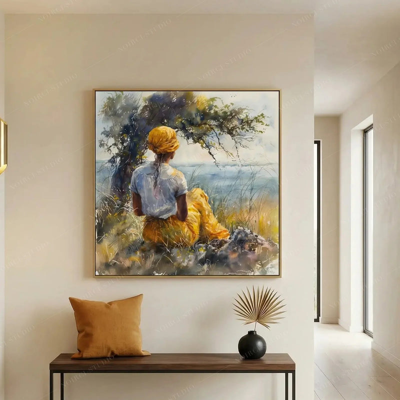 African American art for the entryway, seaside watercolor above a console bench with a mustard pillow and dried palm