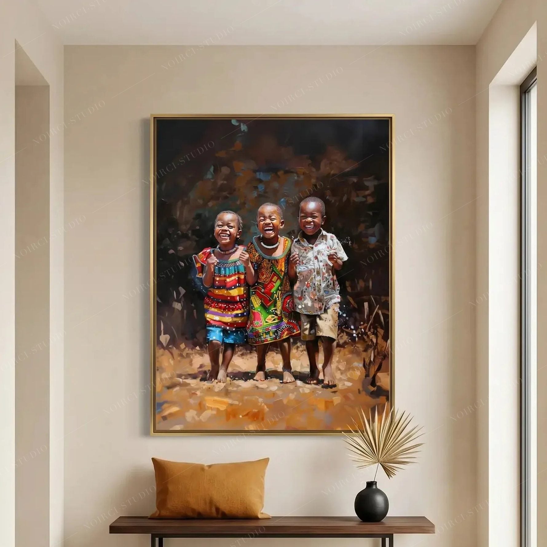 Gold-framed painting of three joyful African children above an entry bench with a mustard pillow and dried palm