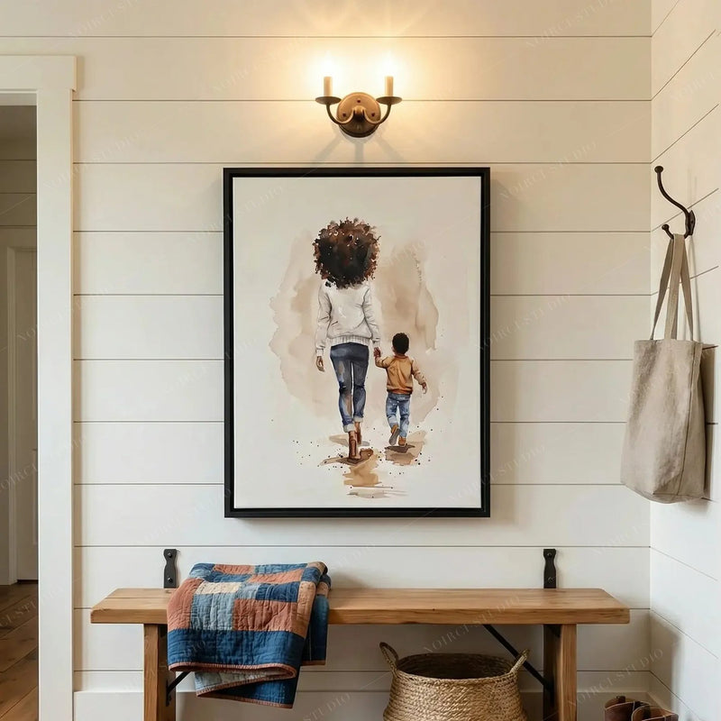 Black family wall art in a shiplap entryway with brass sconce, wood bench and denim quilt, mother and son watercolor