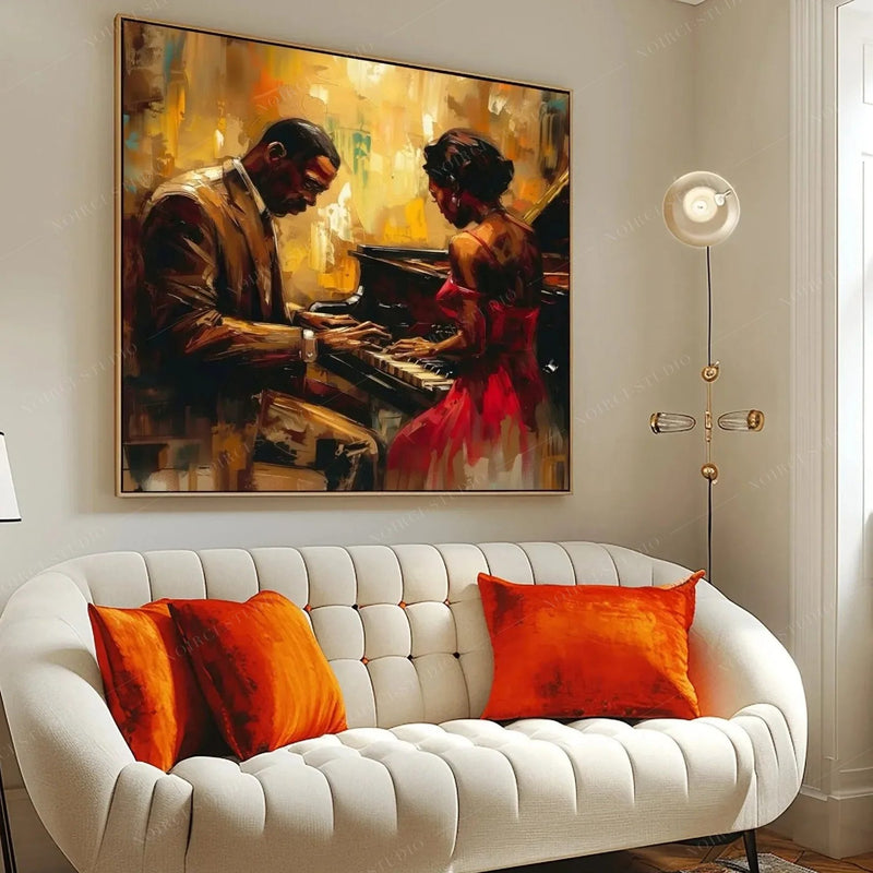 Black art for living room walls, piano couple painting above a cream tufted sofa with orange pillows