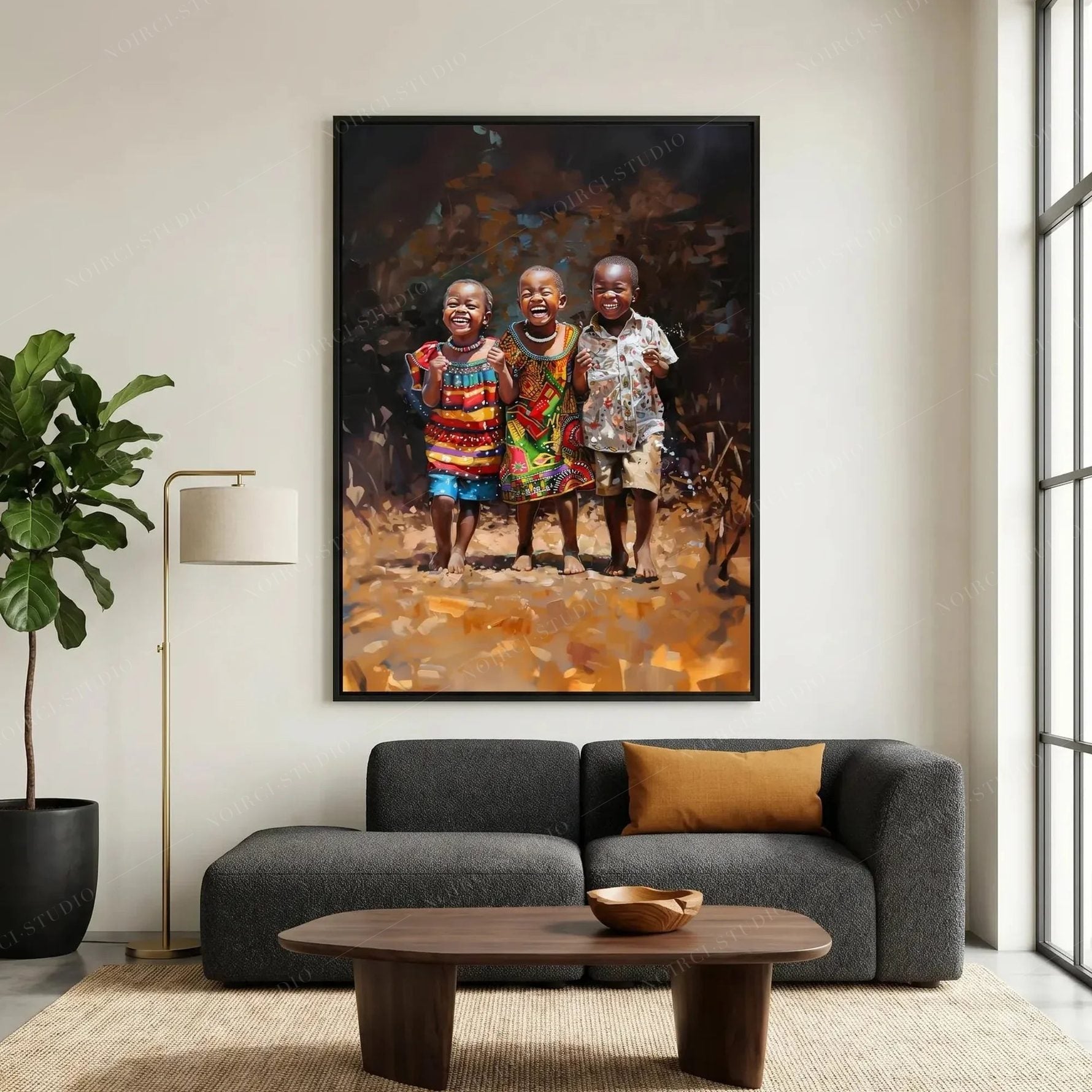 African wall art in a black frame above a charcoal sofa, oil painting of three laughing children in colorful patterned prints
