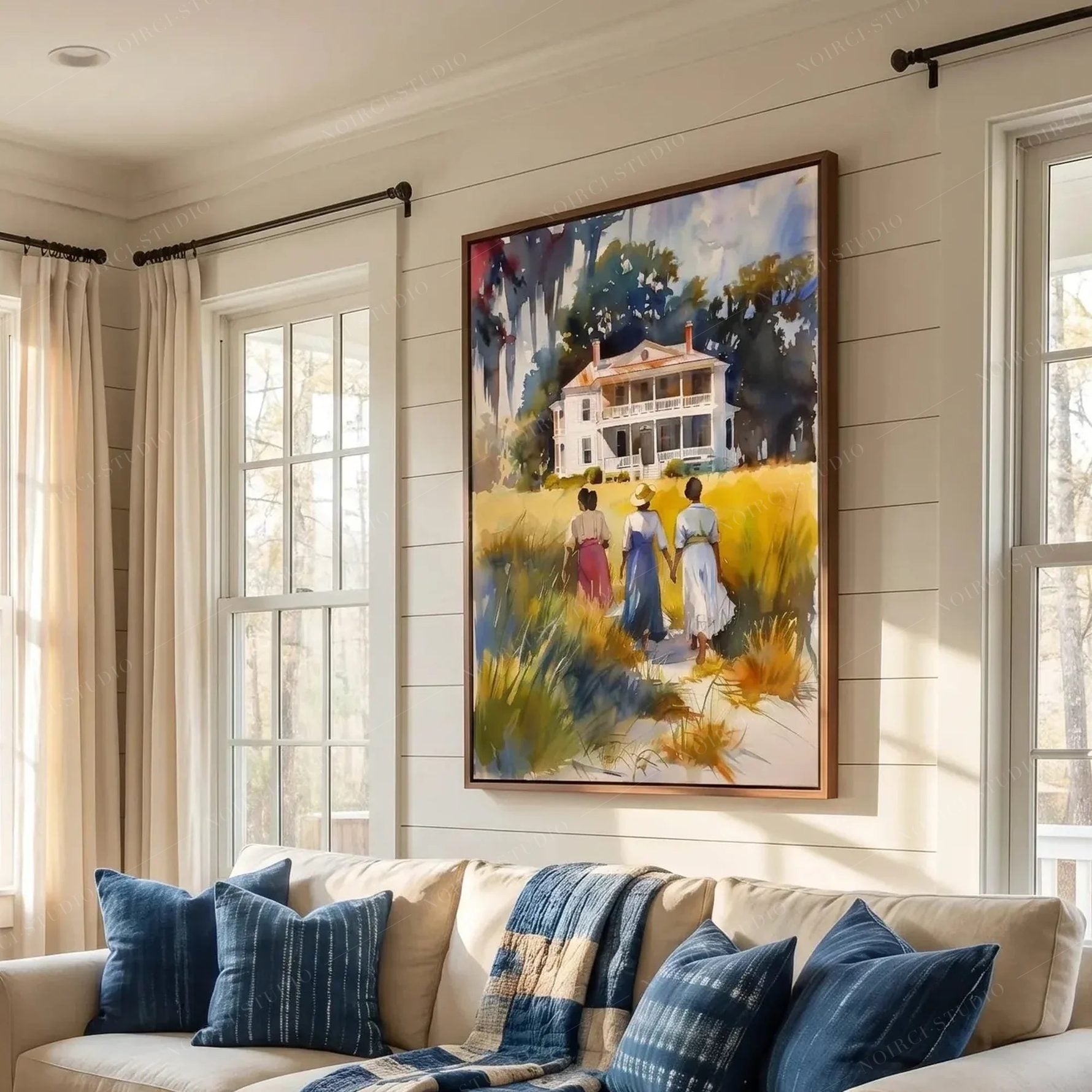 Gullah Geechee art above a sofa with indigo pillows, Lowcountry watercolor in a shiplap farmhouse living room