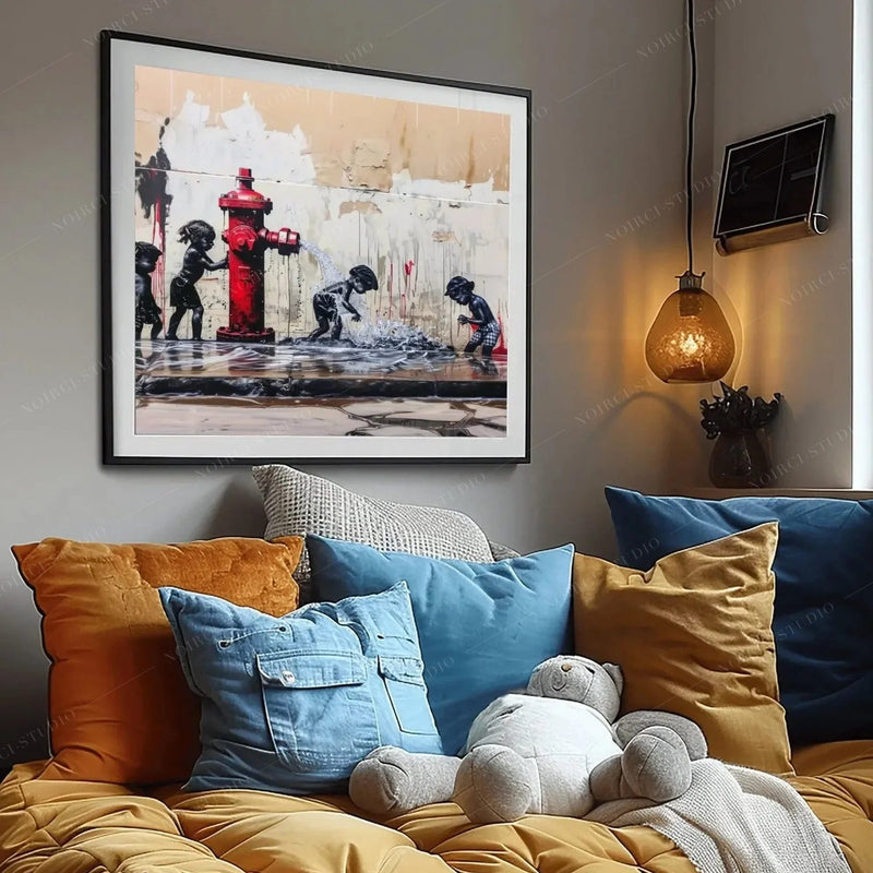 Black art for kids' rooms, framed hydrant print above a bed piled with denim blue and mustard pillows and a teddy bear