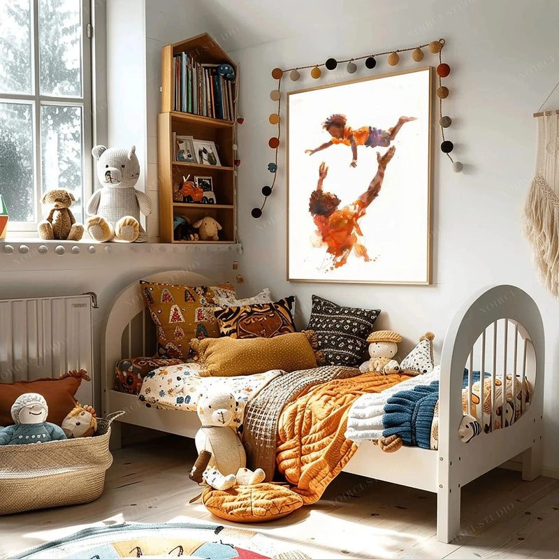 Black art for kids' rooms, father tossing son painting above a white toddler bed with an orange quilt and teddy bears