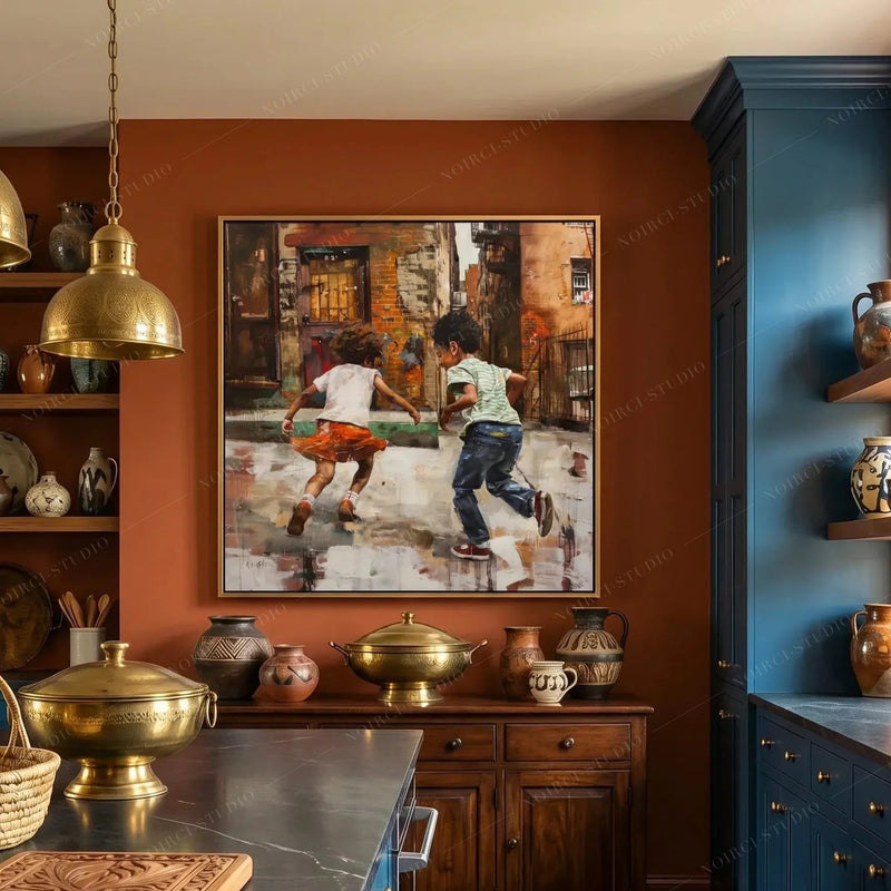 Family black art in a gold frame on a terracotta wall, kitchen with navy cabinets and brass cookware below