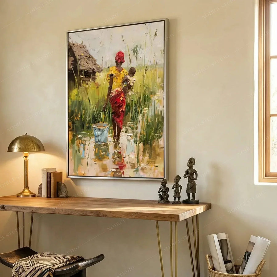 African American art for a home office, mother carrying baby painting above a wood desk with carved statues