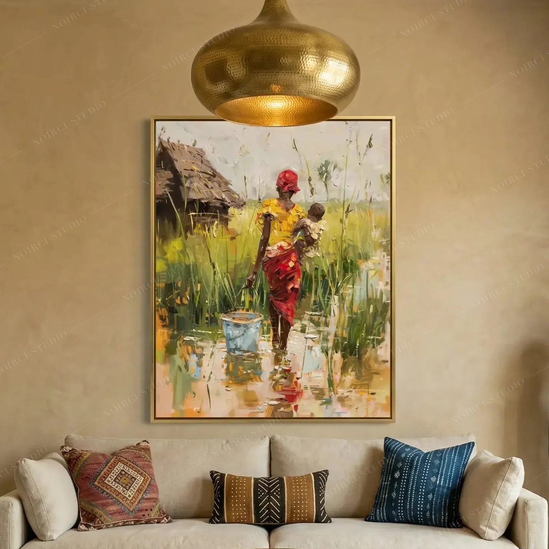 Black art for living room, mother and baby village canvas above a cream sofa with patterned pillows