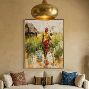 Black art for living room, mother and baby village canvas above a cream sofa with patterned pillows
