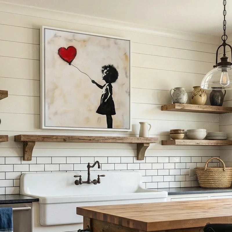 Black farmhouse wall decor, girl with balloon in a white frame above open wood shelves and a farmhouse sink
